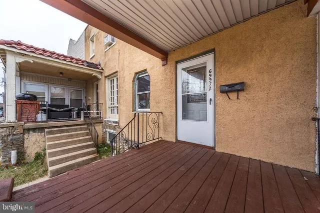 a view of a patio with wooden floor
