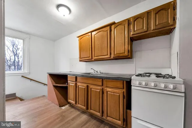 a kitchen with stainless steel appliances granite countertop a stove and a microwave