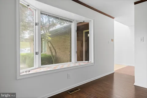 a utility room with cabinets a sink and a window