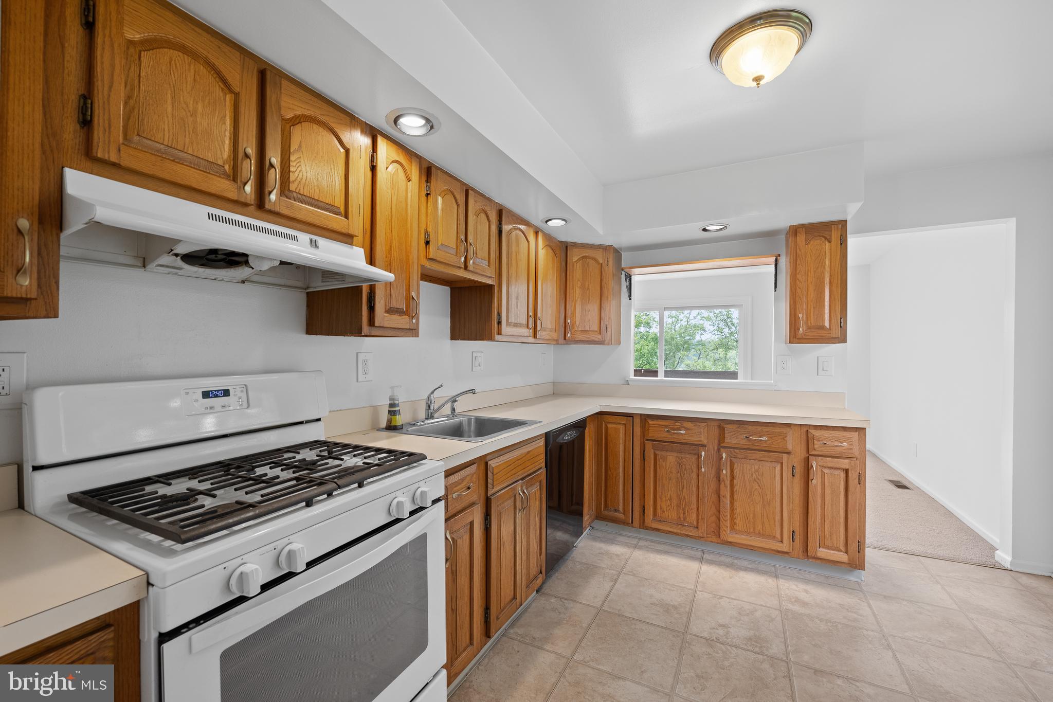 105 Timothy Circle Wayne, PA 19087 - Photo 13 of 31 a kitchen with stainless steel appliances granite countertop a stove a sink and a microwave