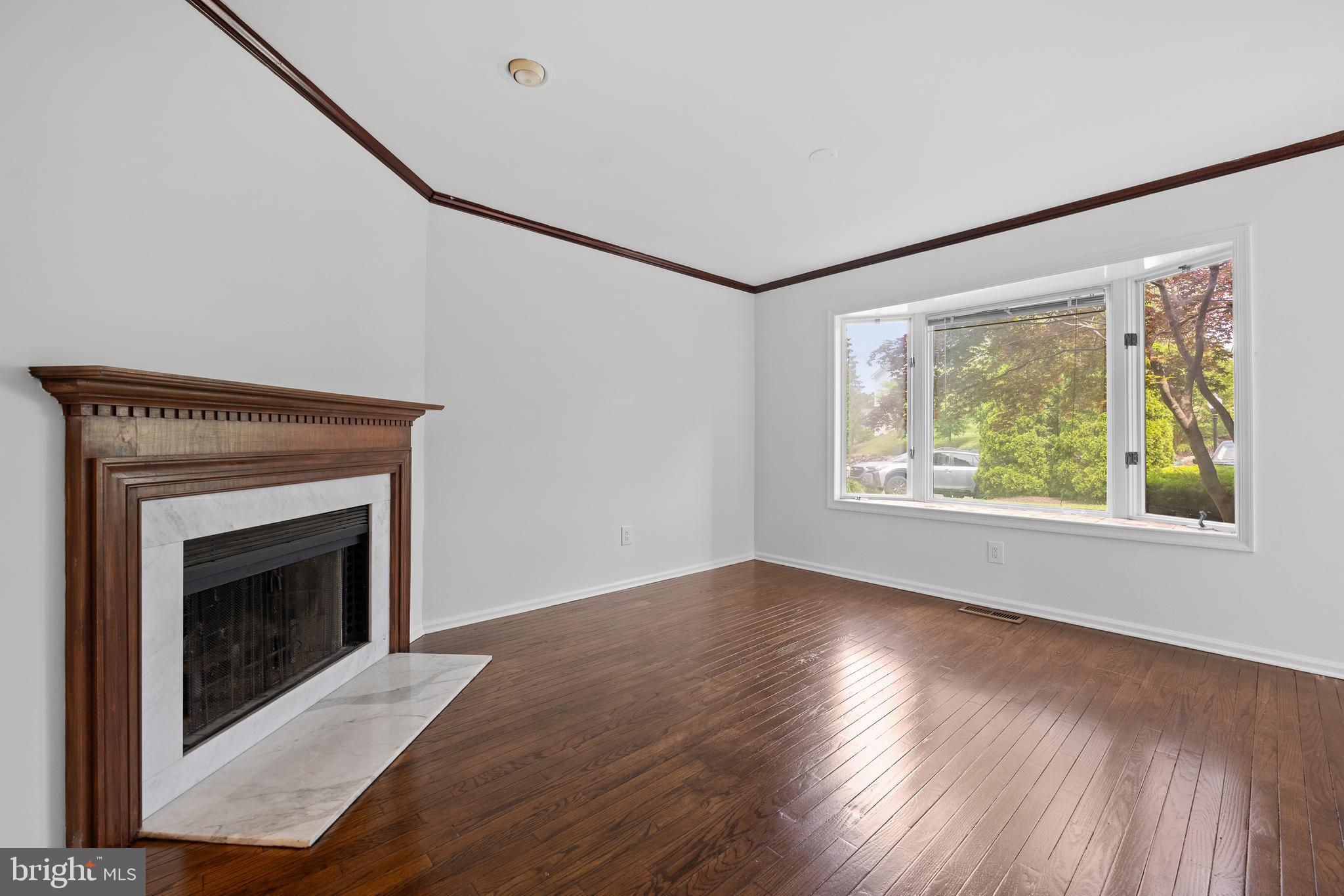 105 Timothy Circle Wayne, PA 19087 - Photo 10 of 31 a view of an empty room with wooden floor fireplace and a window