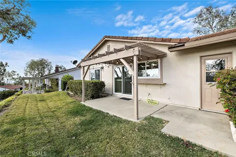a view of a house with backyard and porch