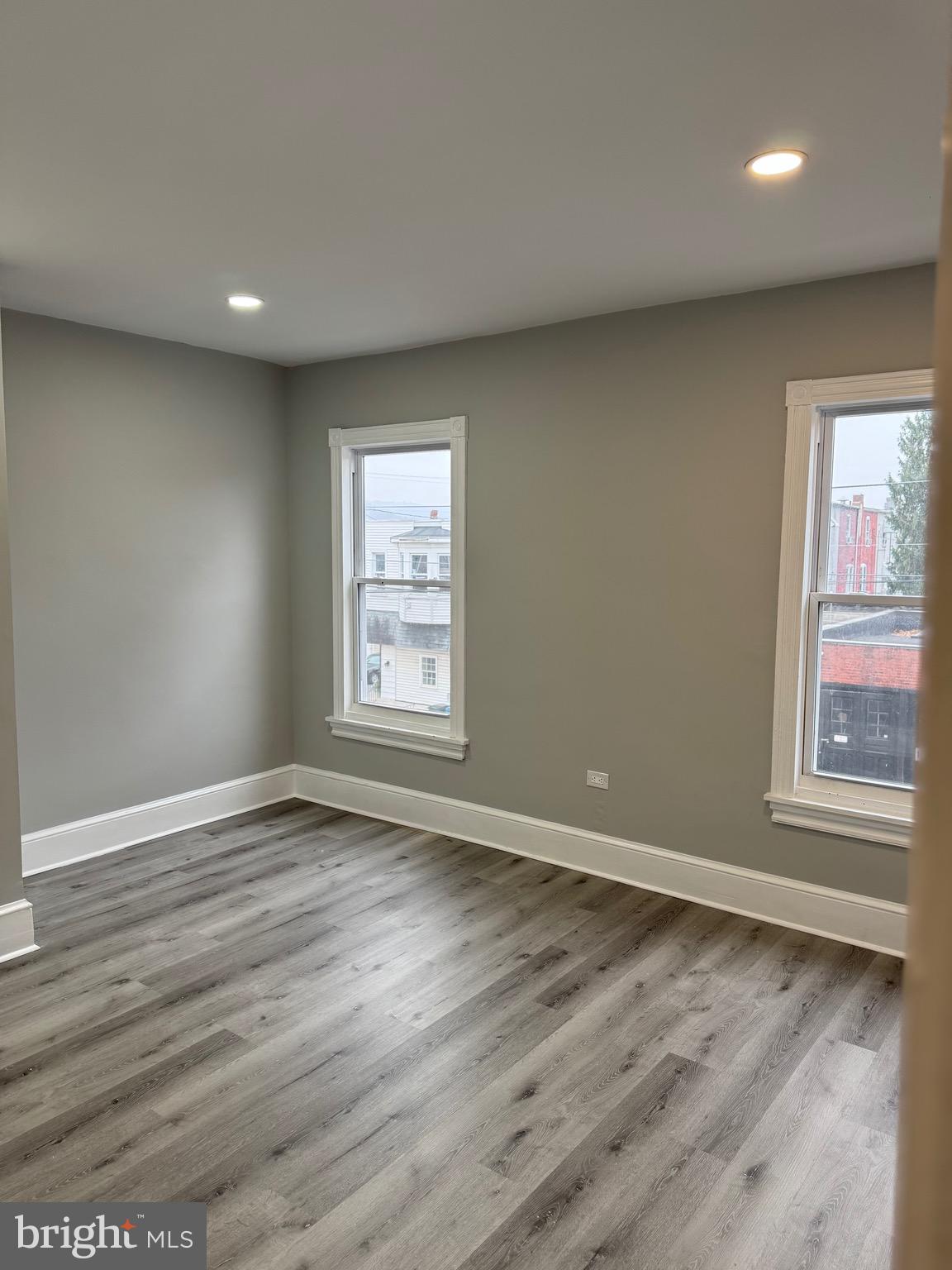 521 Windsor Street Reading, PA 19601 - Photo 11 of 14 an empty room with wooden floor and windows