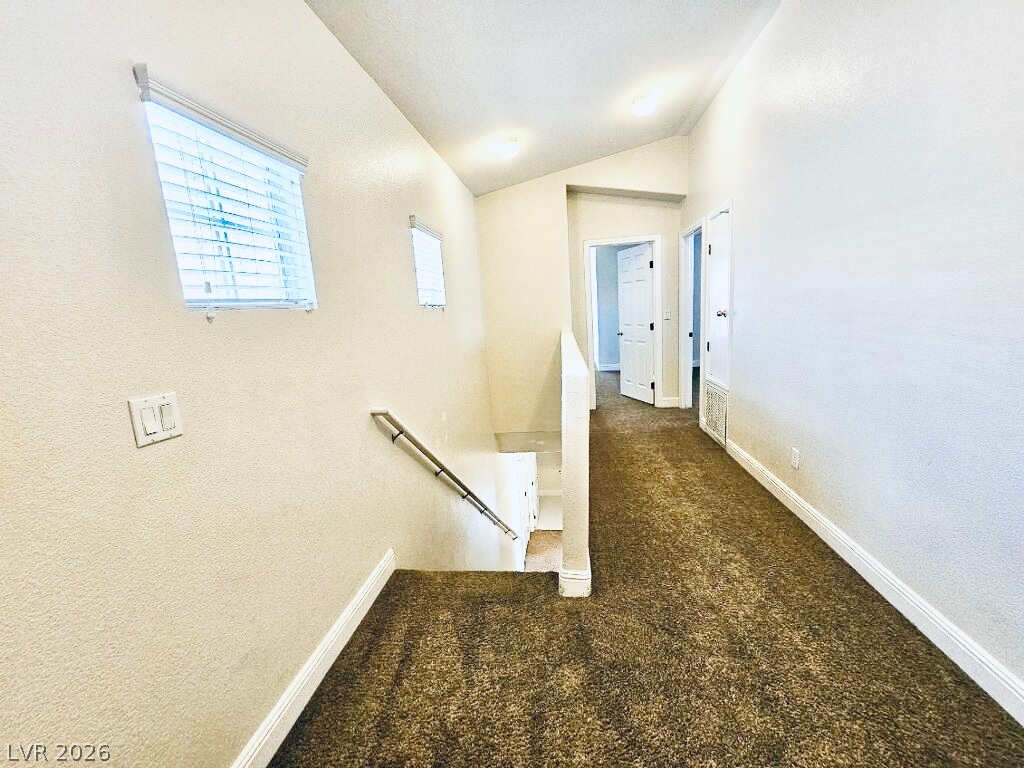5953 Crumbling Ridge Street Henderson, NV 89011 - Photo 13 of 42 A welcoming upper-level landing with plush carpeting, leading to various rooms, with natural illumination from two windows.