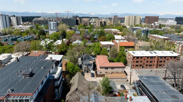 an aerial view of multiple houses with yard