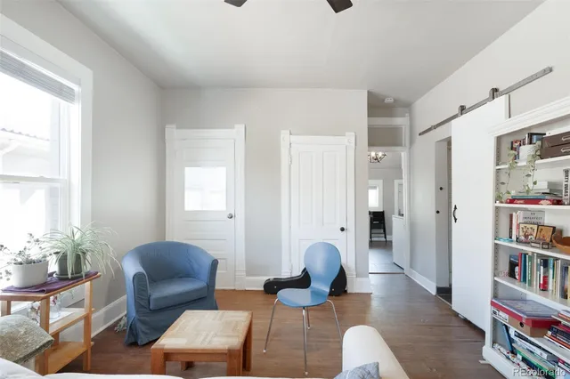 a living room with furniture and a book shelf