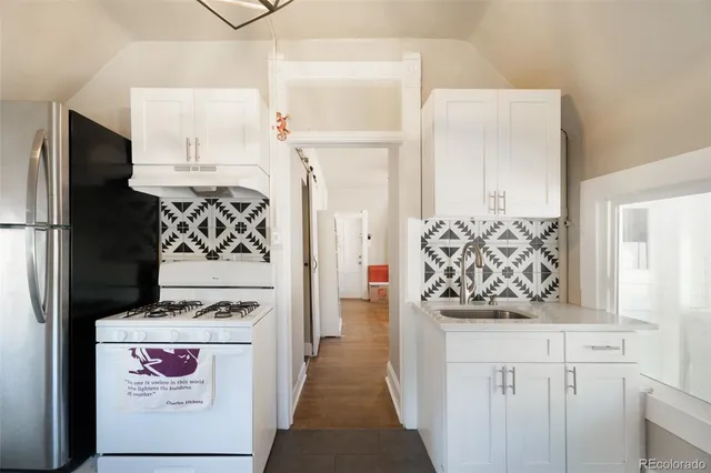 a hallway with stove and refrigerator