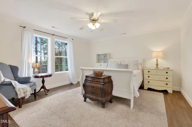 a bedroom with furniture and a large window