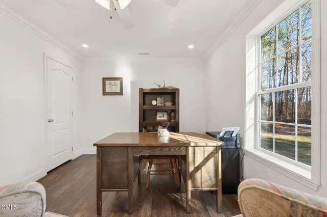 a dining room with furniture and wooden floor