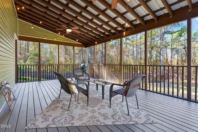 a roof deck with a dining table and chairs with wooden floor