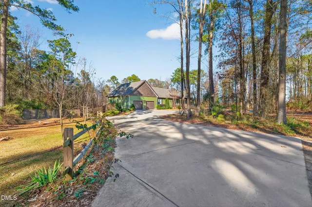 a view of a house with a yard and tree s