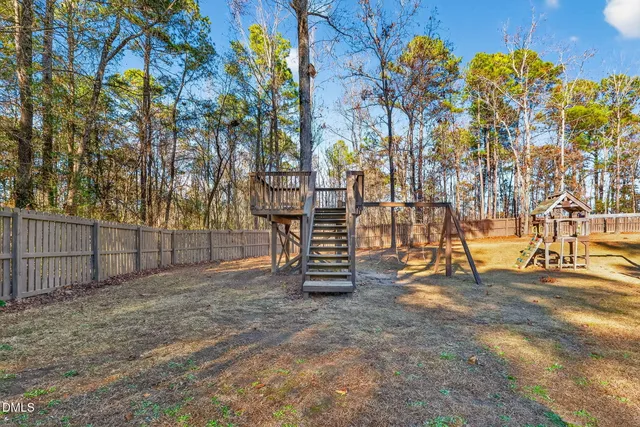 a view of a house with a swimming pool and a yard