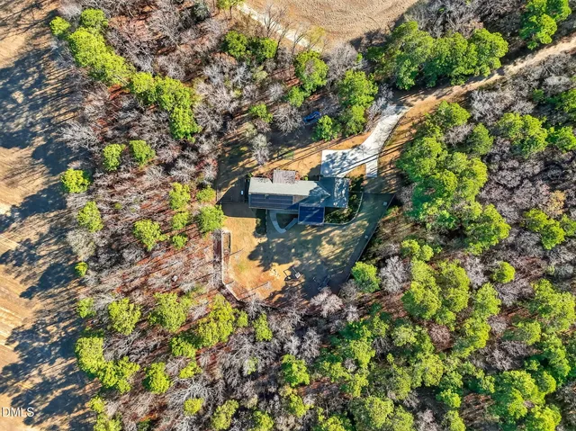 a backyard of a house with a yard and outdoor seating