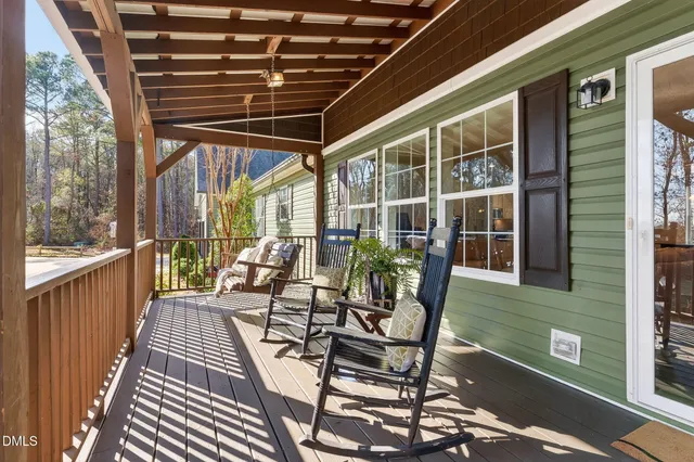 a view of a patio with table and chairs and wooden floor
