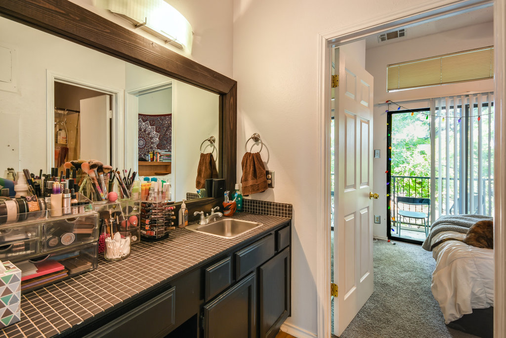 2802 Nueces Street, Unit 307 Austin, TX 78705 - Photo 12 of 16 a bathroom with a sink and a mirror
