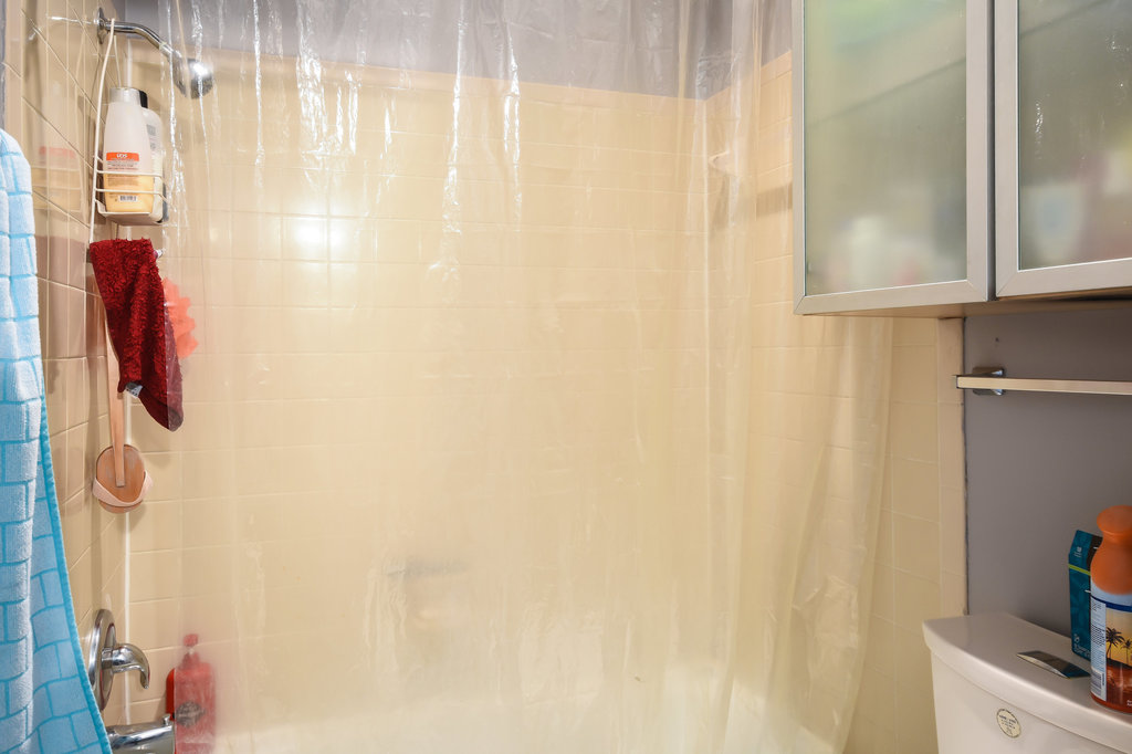 2802 Nueces Street, Unit 307 Austin, TX 78705 - Photo 13 of 16 a bathroom with a shower curtain