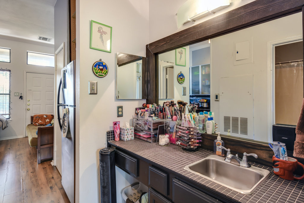 2802 Nueces Street, Unit 307 Austin, TX 78705 - Photo 15 of 16 a bathroom with a sink double vanity and a mirror