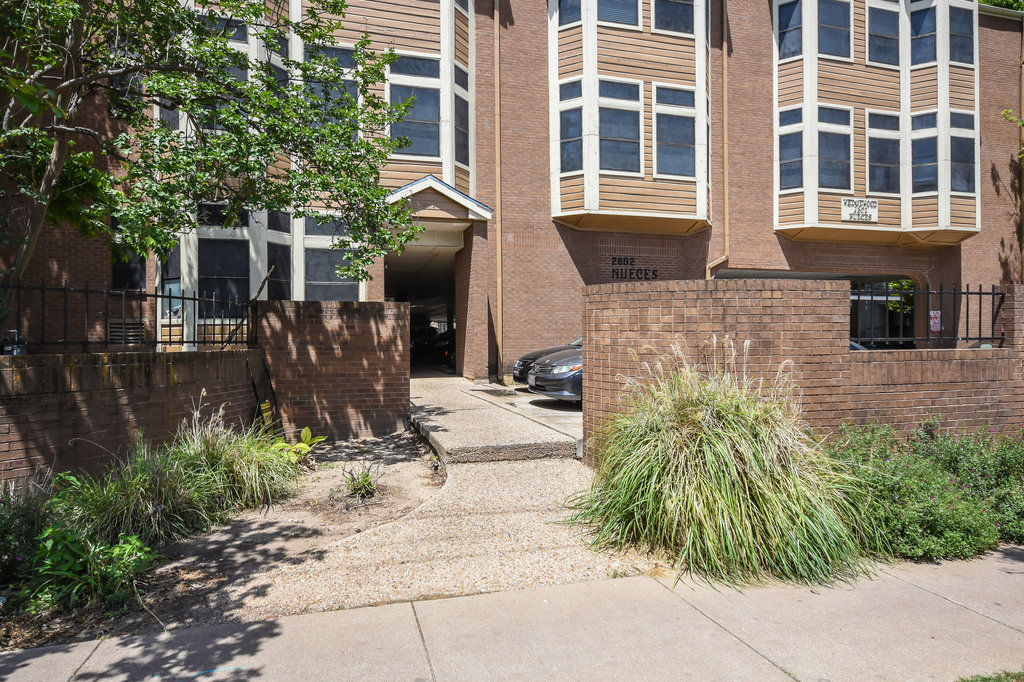 2802 Nueces Street, Unit 307 Austin, TX 78705 - Photo 2 of 16 a front view of a house with garden