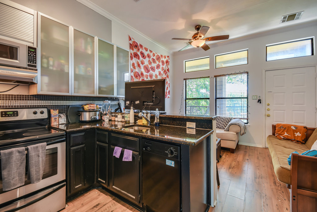 2802 Nueces Street, Unit 307 Austin, TX 78705 - Photo 10 of 16 a kitchen with stainless steel appliances granite countertop a stove and a sink