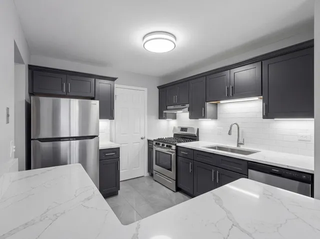 a bathroom with a shower sink vanity mirror and toilet