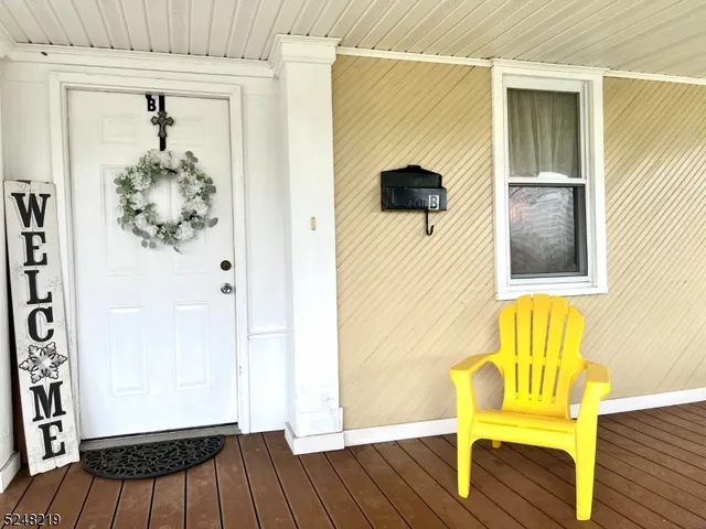 a view of a hallway with wooden floor and door