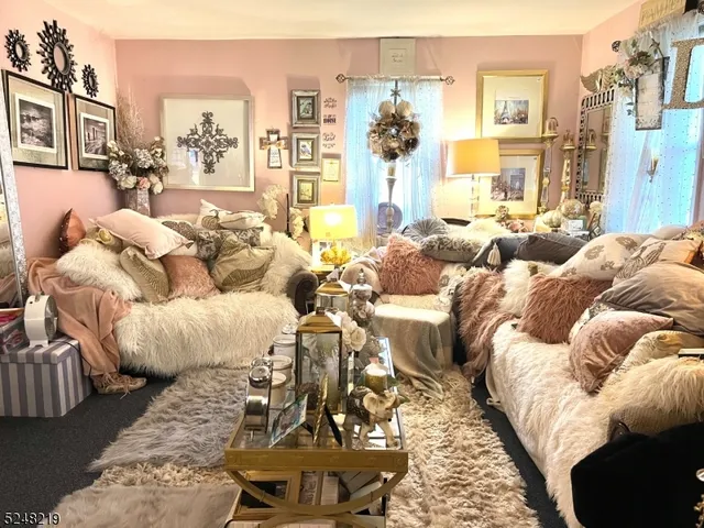 a living room with furniture and a dining table