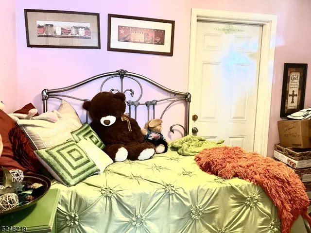 a living room with furniture a flat screen tv and a bed