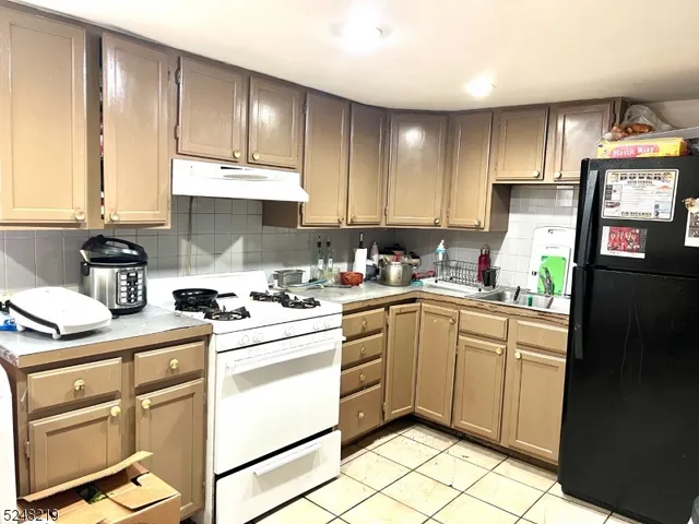 a kitchen with appliances cabinets and furniture