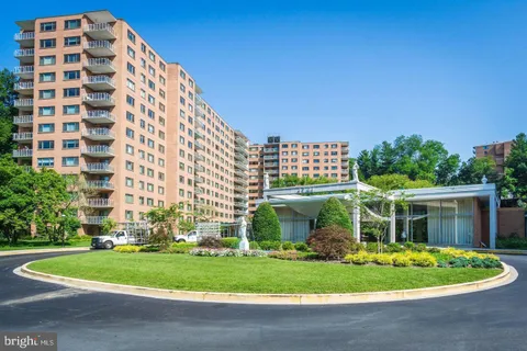 a front view of a building with a garden