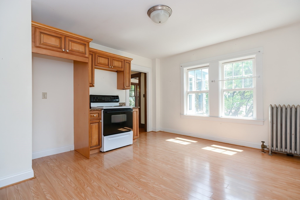2 Prospect Street Milford, MA 01757 - Photo 17 of 31 a view of an empty room with a kitchen and a window