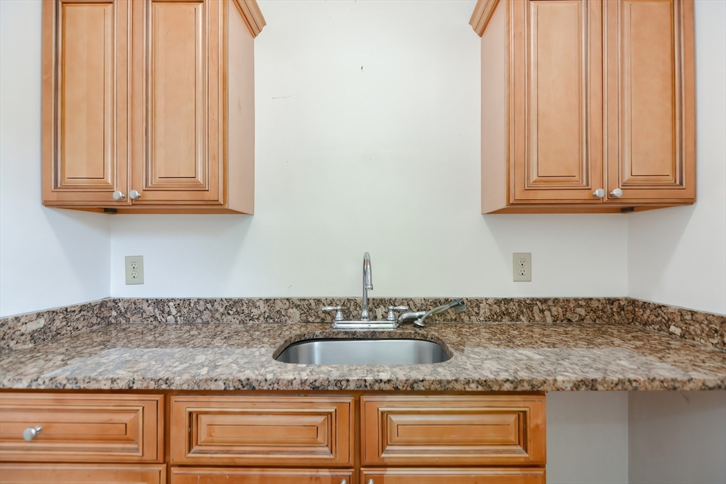 2 Prospect Street Milford, MA 01757 - Photo 18 of 31 a kitchen with granite countertop white cabinets and a sink