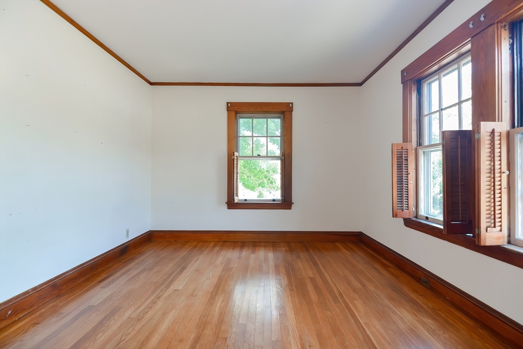 2 Prospect Street Milford, MA 01757 - Photo 21 of 31 a view of an empty room with wooden floor and a window