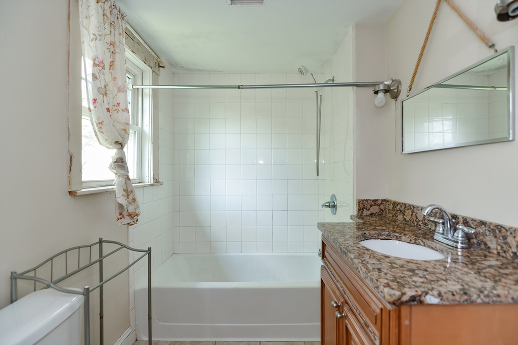 2 Prospect Street Milford, MA 01757 - Photo 28 of 31 a bathroom with a granite countertop sink and a mirror