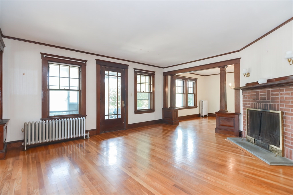 2 Prospect Street Milford, MA 01757 - Photo 6 of 31 an empty room with wooden floor and fireplace