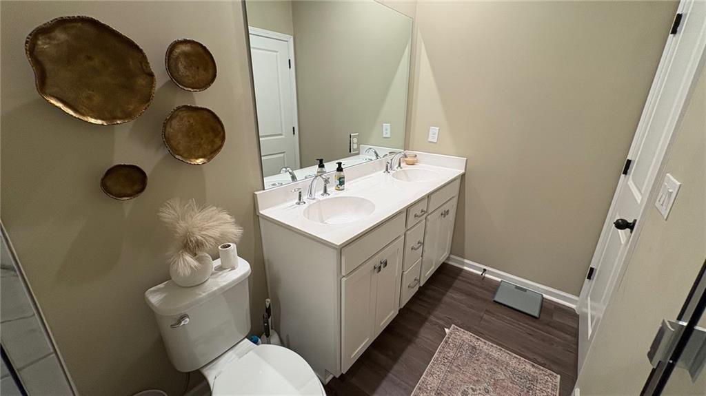 600 Tiller Way Acworth, GA 30102 - Photo 11 of 23 a bathroom with a granite countertop toilet sink and mirror
