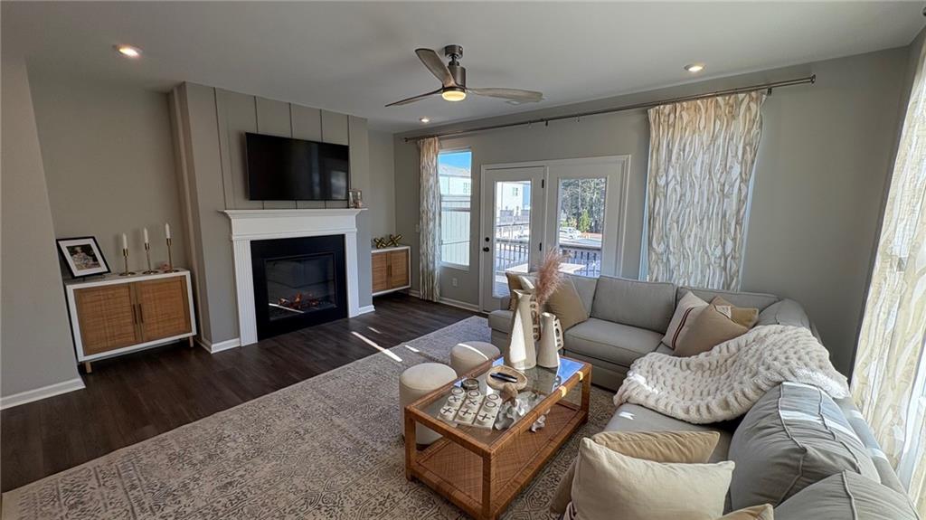 600 Tiller Way Acworth, GA 30102 - Photo 4 of 23 a living room with furniture a fireplace and a flat screen tv