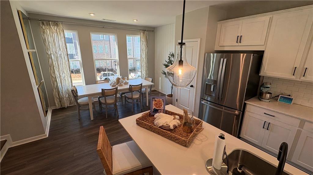 600 Tiller Way Acworth, GA 30102 - Photo 6 of 23 a kitchen with stainless steel appliances a refrigerator a table and chairs