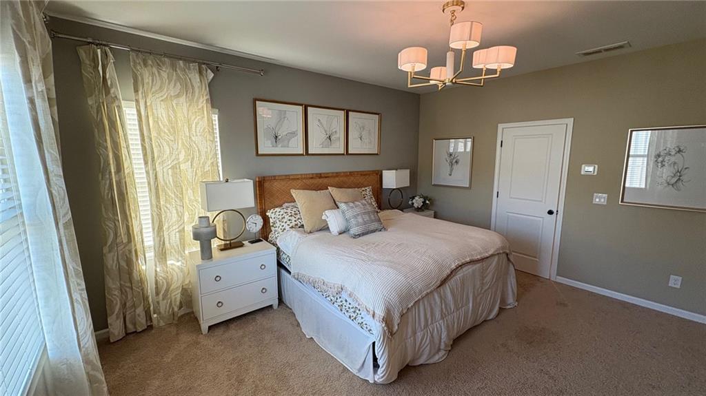 600 Tiller Way Acworth, GA 30102 - Photo 9 of 23 a bedroom with a bed chandelier and a window