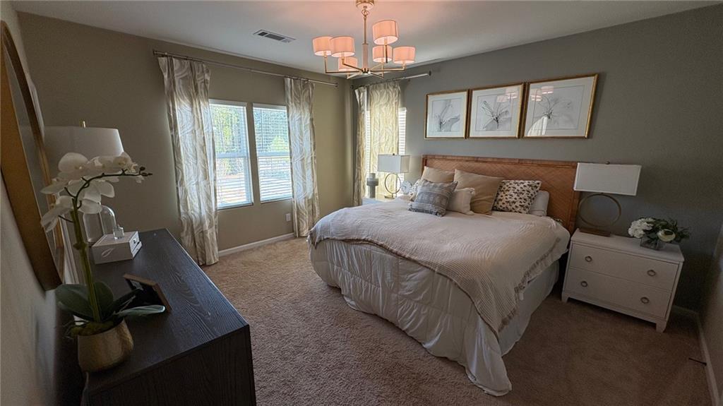 600 Tiller Way Acworth, GA 30102 - Photo 10 of 23 a bedroom with a bed and a chandelier