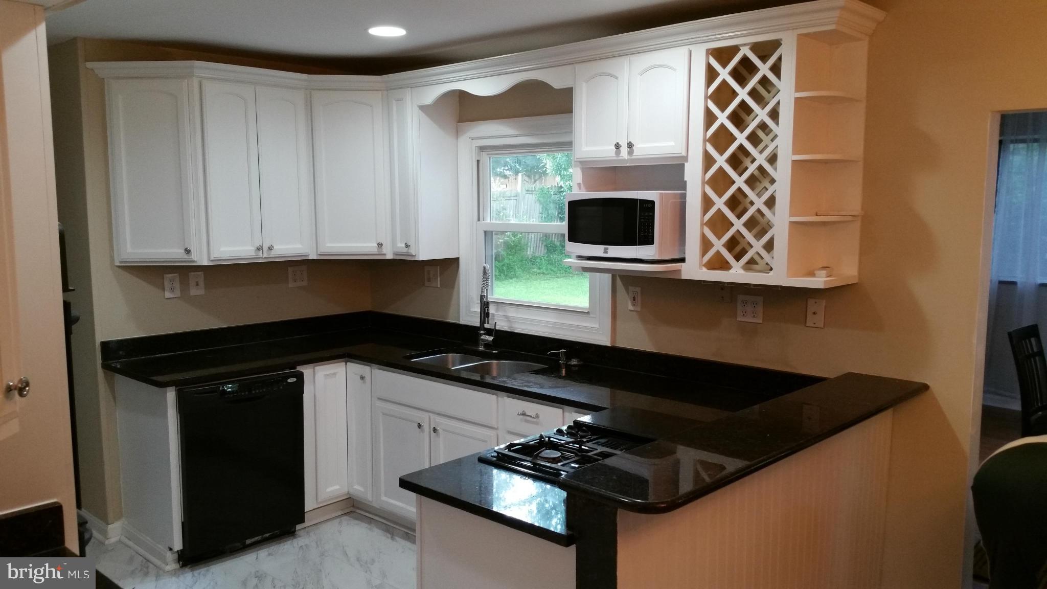12408 Starlight Lane Bowie, MD 20715 - Photo 14 of 26 a kitchen with stainless steel appliances granite countertop a stove a microwave and a sink