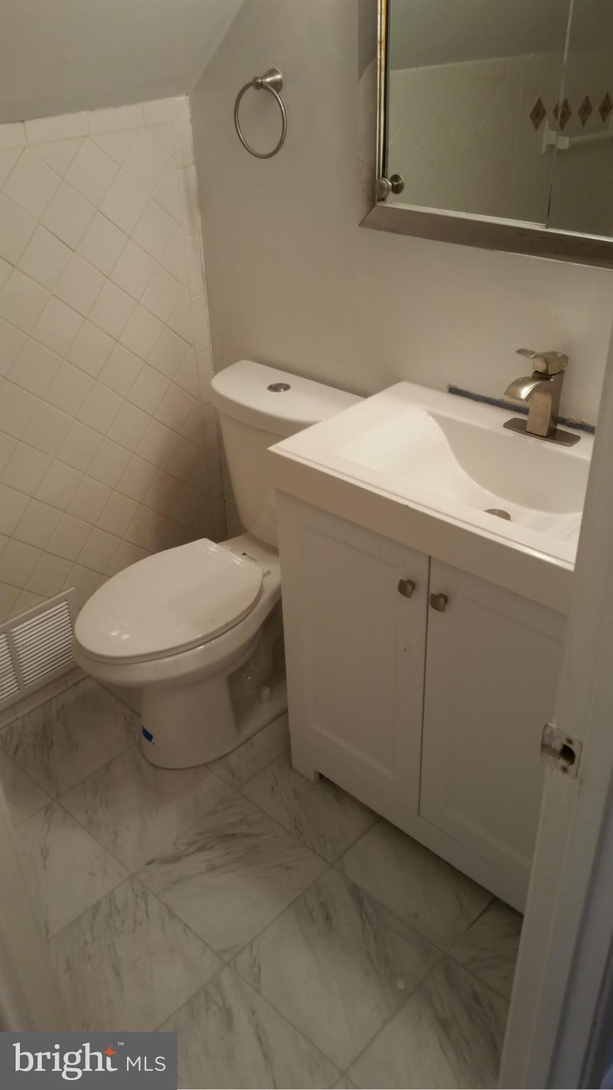 12408 Starlight Lane Bowie, MD 20715 - Photo 19 of 26 a bathroom with a sink toilet and vanity