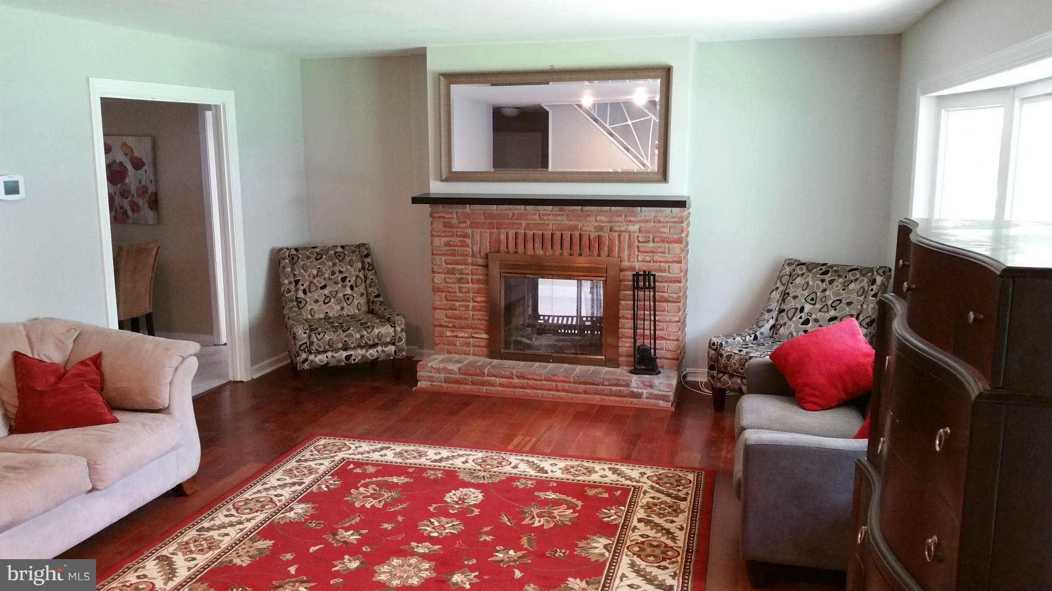 12408 Starlight Lane Bowie, MD 20715 - Photo 3 of 26 a living room with furniture and a fireplace