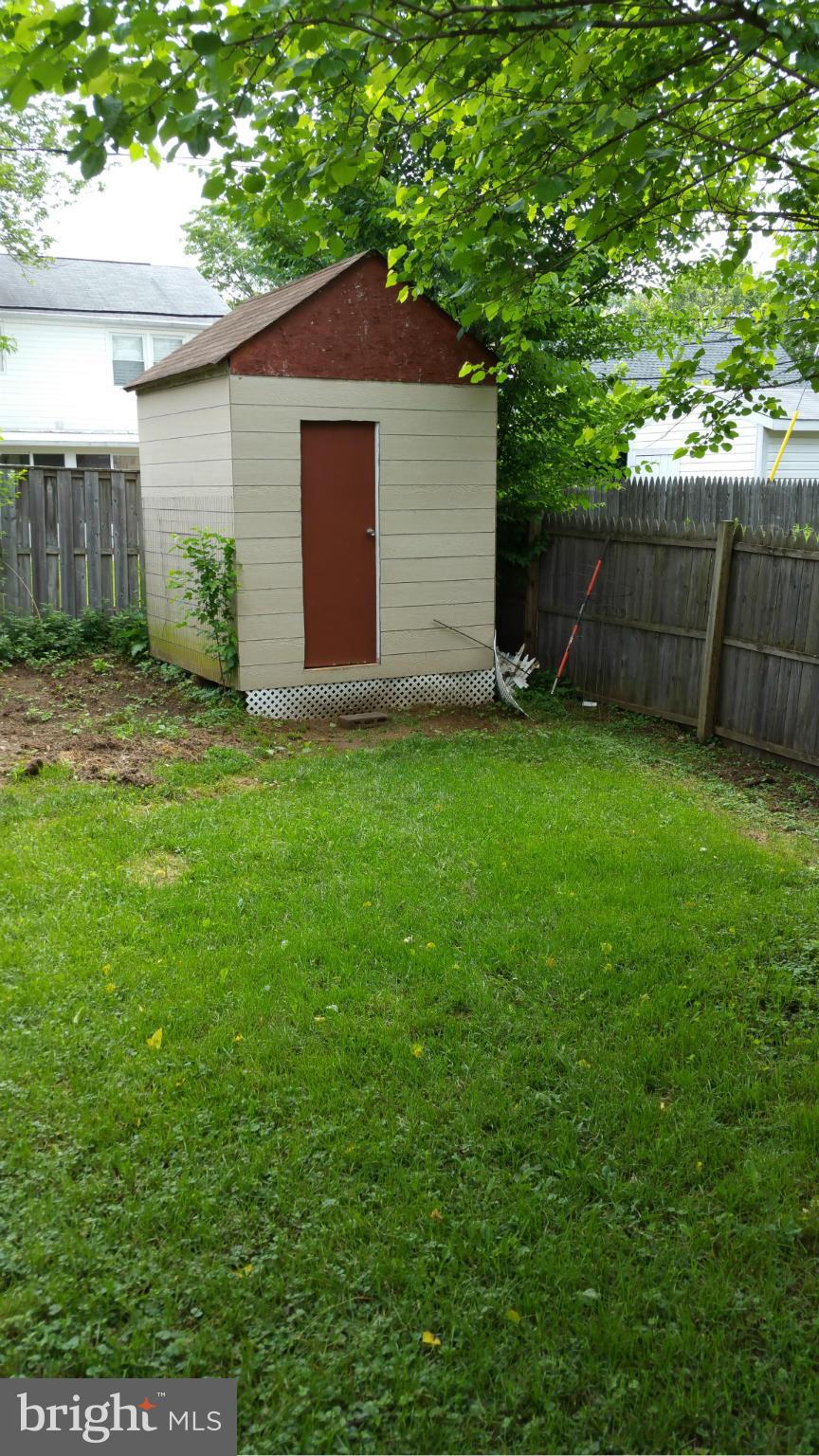12408 Starlight Lane Bowie, MD 20715 - Photo 23 of 26 a backyard of a house with plants and large tree