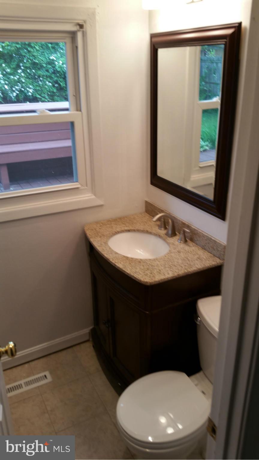 12408 Starlight Lane Bowie, MD 20715 - Photo 24 of 26 a bathroom with a sink a toilet and a mirror