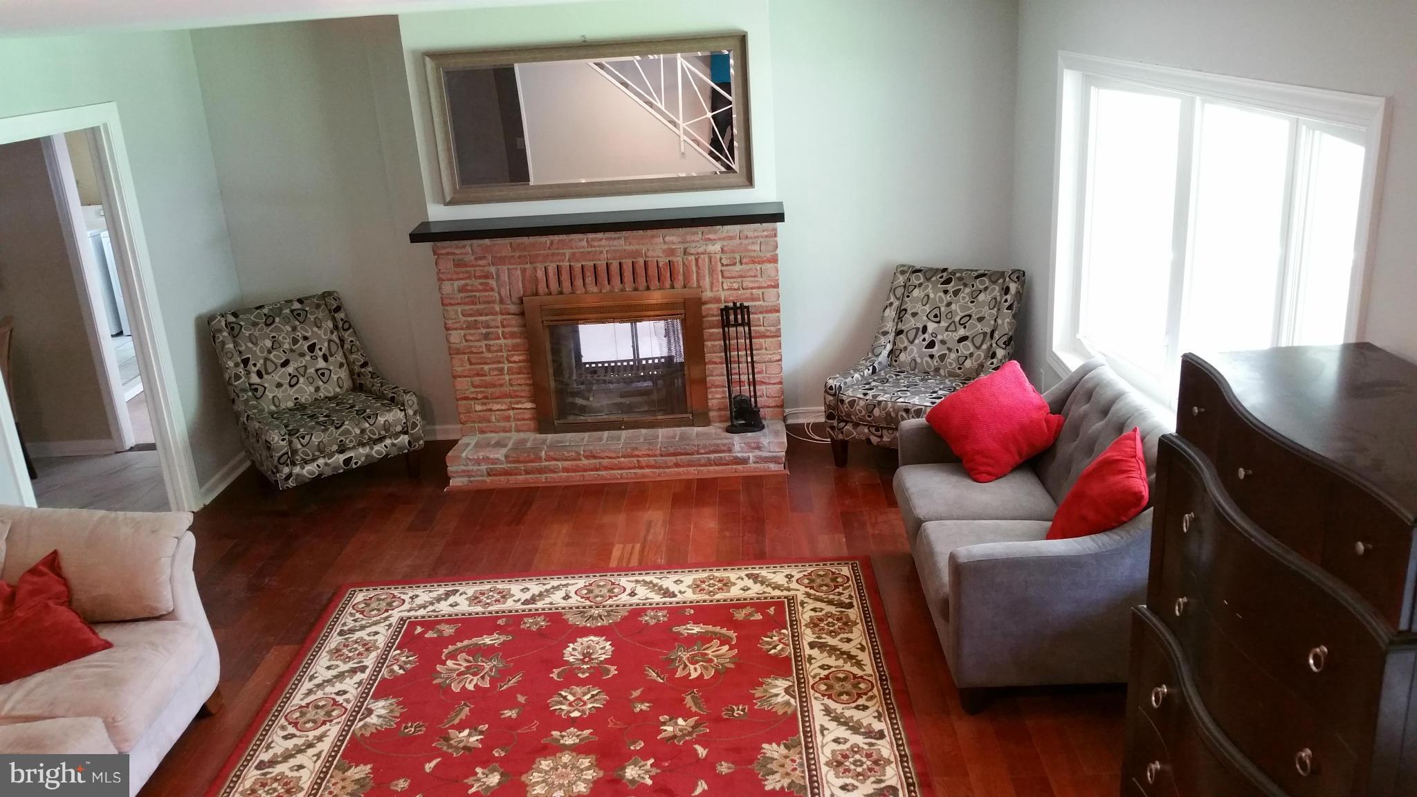 12408 Starlight Lane Bowie, MD 20715 - Photo 4 of 26 a living room with furniture and a fireplace