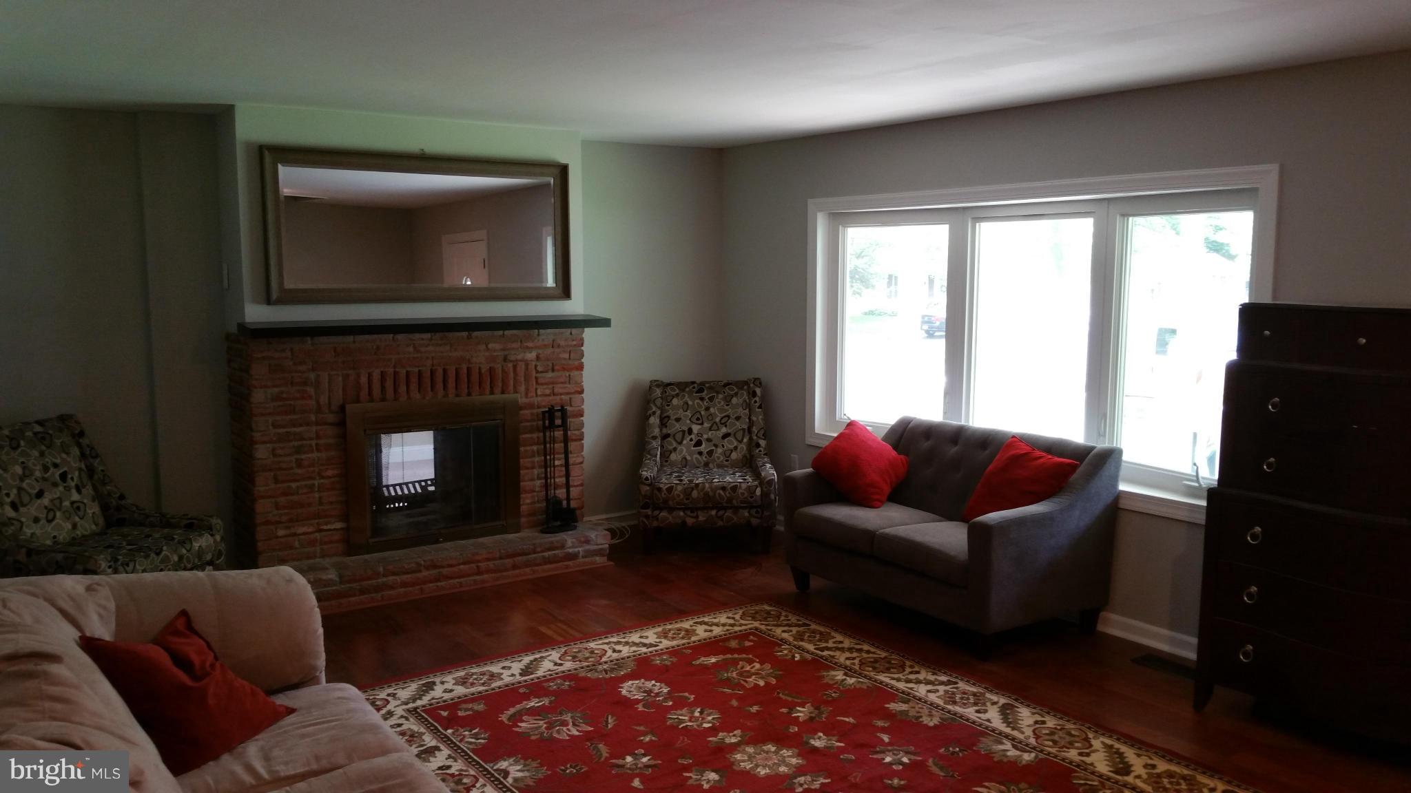 12408 Starlight Lane Bowie, MD 20715 - Photo 5 of 26 a living room with furniture and a fireplace