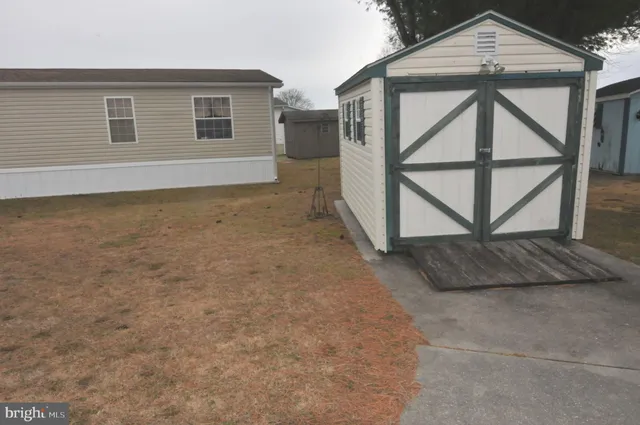 a view of a house with backyard and deck