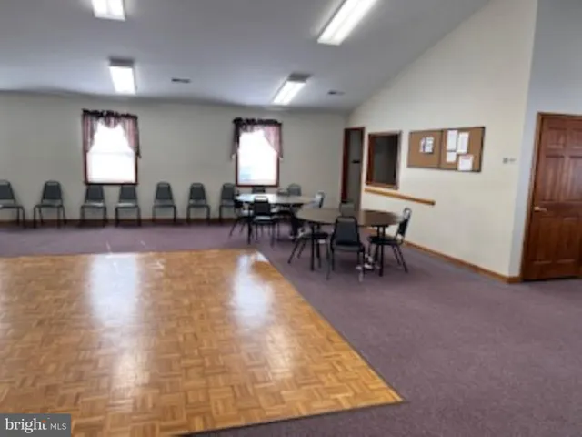 a living room with fireplace furniture and a window