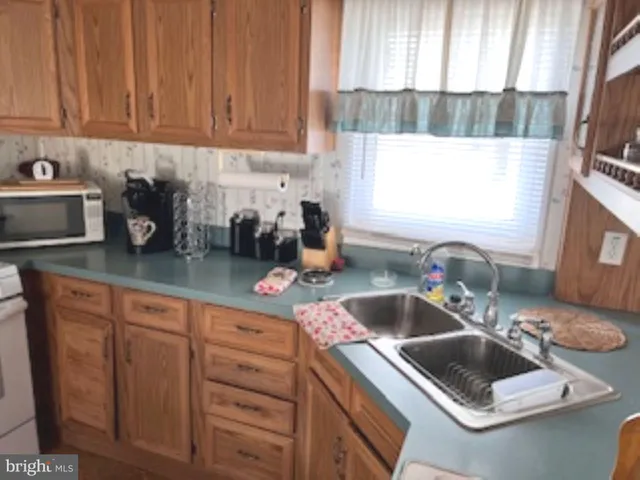 a kitchen with sink and window