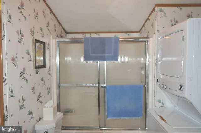 a bathroom with a glass shower door